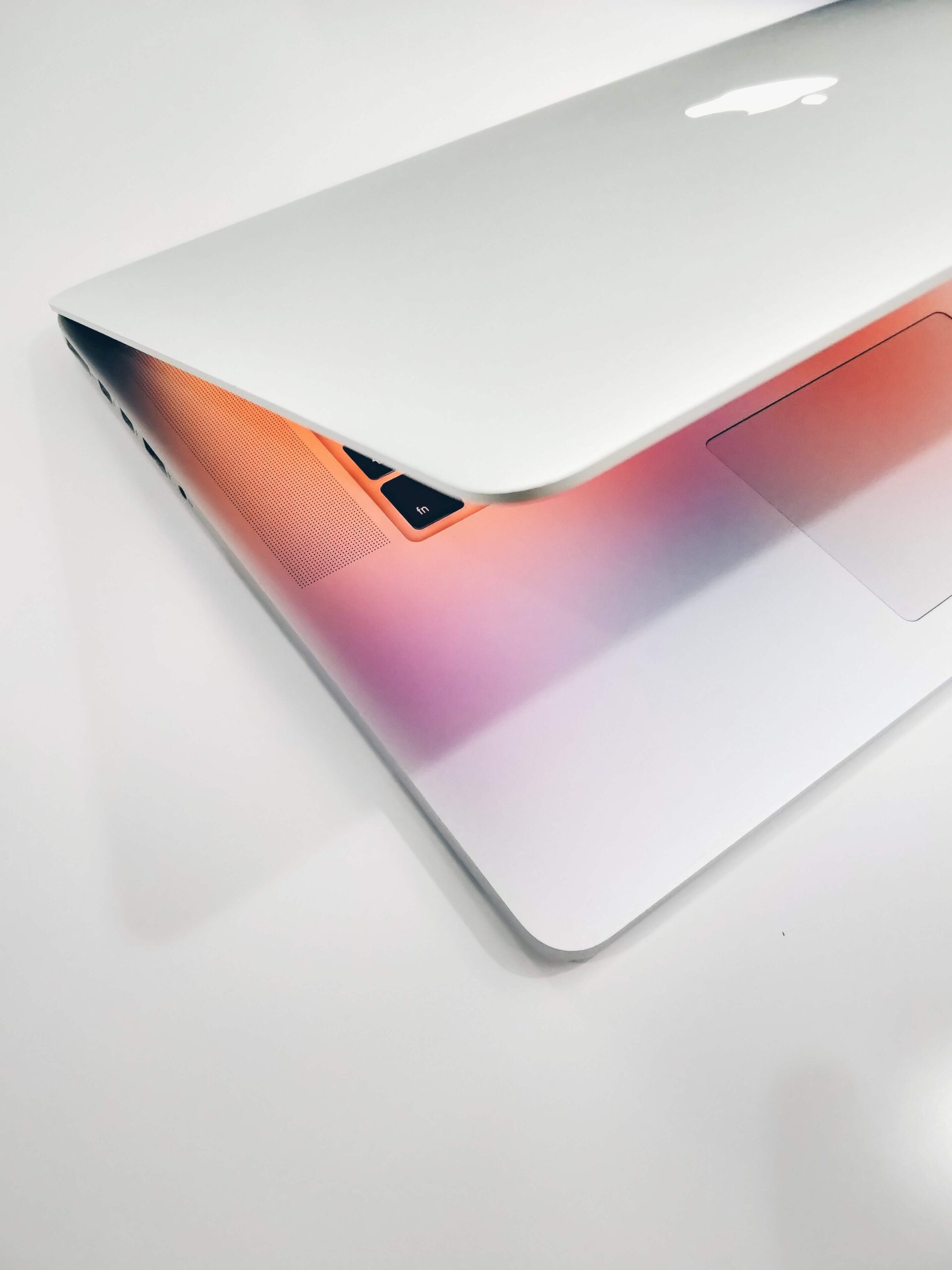 white macbook with orange and pinks